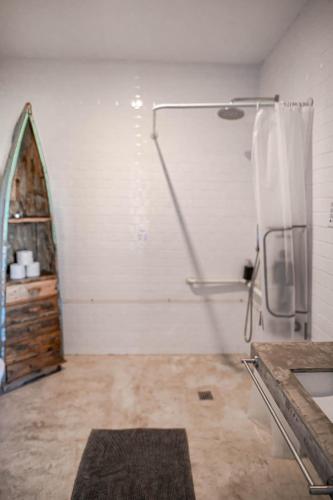 a bathroom with a shower and a sink in a room at Surfers Lodge Peniche in Peniche