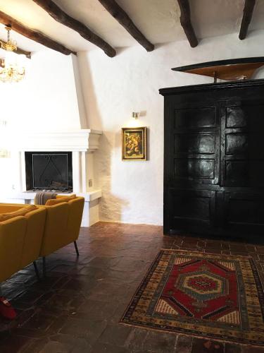 a living room with a black door and a rug at El Molino Estepona in Estepona
