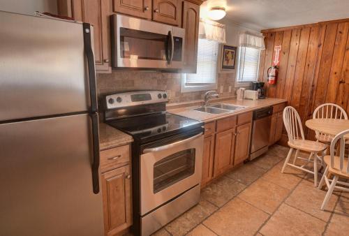 a kitchen with a stainless steel refrigerator and a sink at Outer Banks Motel in Buxton