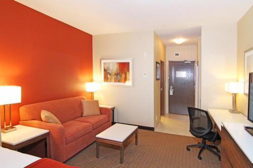 a hotel room with a couch and a table at Holiday Inn Express and Suites Calgary University by IHG in Calgary