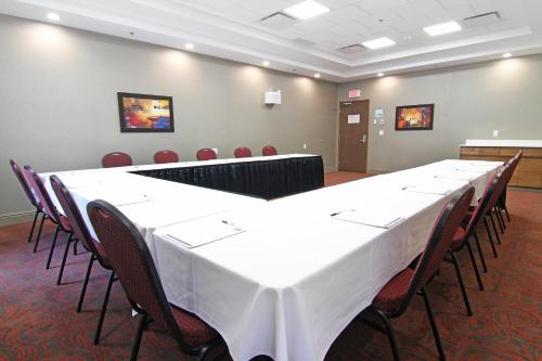 a large conference room with a long table and chairs at Holiday Inn Express and Suites Calgary University by IHG in Calgary