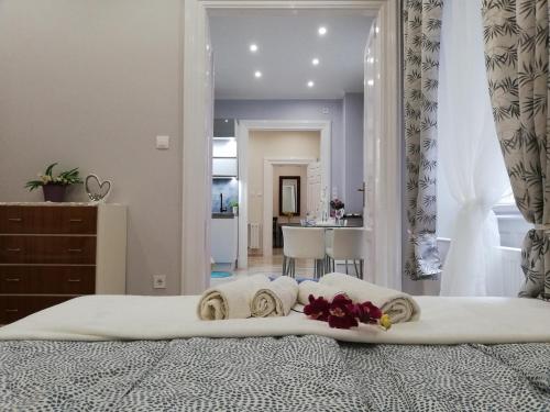 a bedroom with a bed with towels on it at PANNONIA Budapest Center DELUXE in Budapest