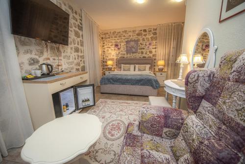 a bedroom with a bed and a living room at Antika Guesthouse in Kotor