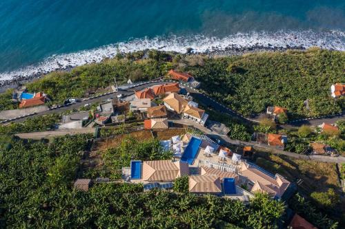 an aerial view of a house next to the ocean at Escarpa - The Madeira Hideaway in Ponta do Sol