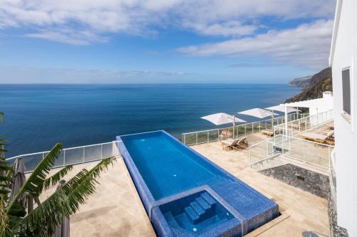 a view of the ocean from a house with a swimming pool at Escarpa - The Madeira Hideaway in Ponta do Sol