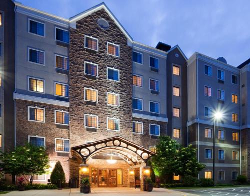 a large building with an archway in front of it at Staybridge Suites Minneapolis-Bloomington by IHG in Bloomington