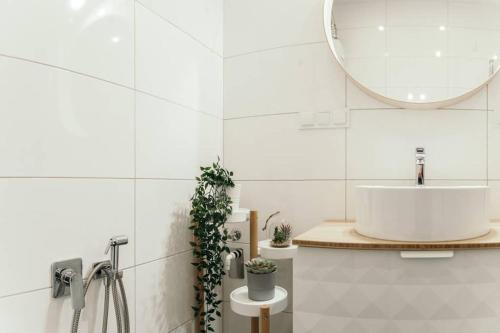 a bathroom with a sink and a mirror at Hello Apartments RAI Rajska in Gdańsk