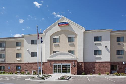 a front view of a hotel with an american flag at Candlewood Suites Craig-Northwest, an IHG Hotel in Craig