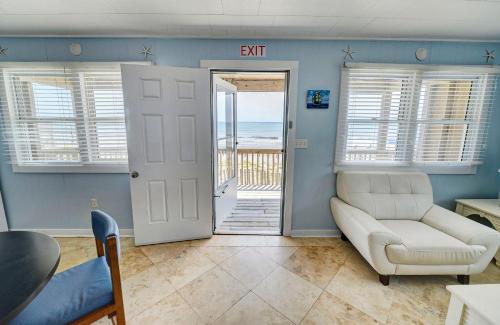 a living room with a couch and a view of the ocean at Outer Banks Motel in Buxton