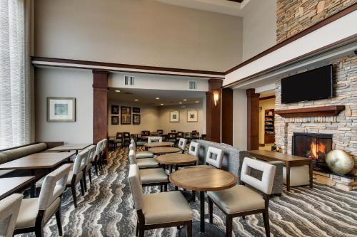 a restaurant with tables and chairs and a fireplace at Staybridge Suites Missoula by IHG in Missoula