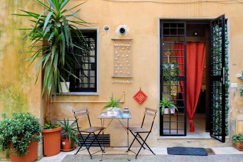 a table and chairs in front of a house at Relax Chiavari House in Rome