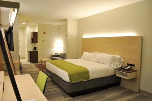 a hotel room with a large bed and a desk at Holiday Inn Express & Suites Price by IHG in Price