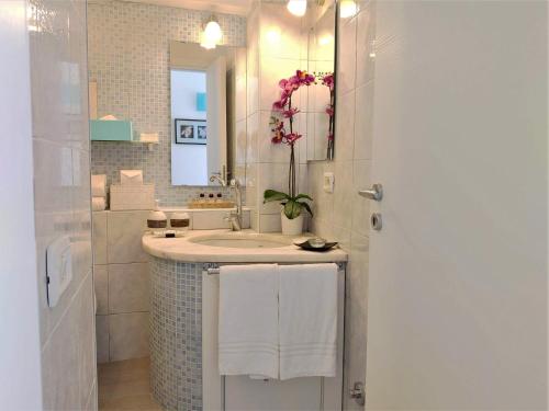 a bathroom with a sink and a mirror at La Petite Maison in Taormina