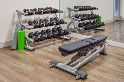a gym with two racks of dumbbells and a simulator at Holiday Inn Express South Portland by IHG in South Portland