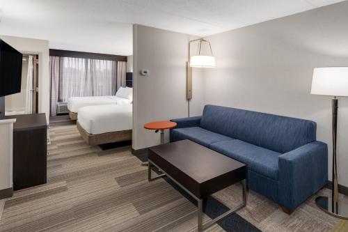 a hotel room with a couch and a bed at Holiday Inn Express South Portland by IHG in South Portland