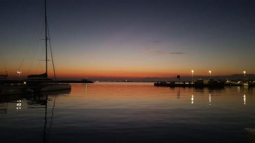 a sunset over a body of water with boats at Sanne in Roses