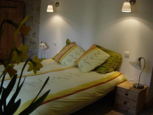 a bed with two pillows on it in a room at Les Chanterelles Montmin in Plan Motmin