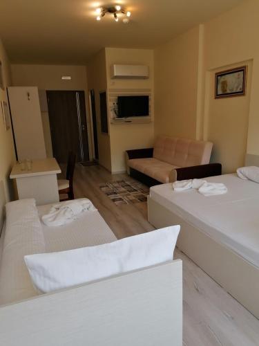 a living room with two beds and a couch at Hotel Lago Peshtera in Peshtera