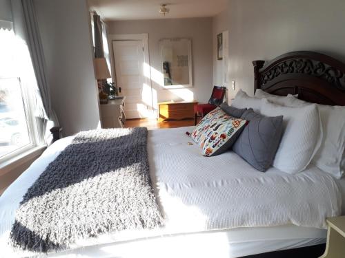 a bedroom with a large white bed with pillows at Hillside Landing B&B in Digby