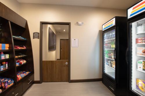 a store aisle with a door and a refrigerator at Staybridge Suites Rapid City - Rushmore by IHG in Rapid City