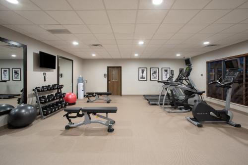 a gym with several treadmills and exercise machines at Staybridge Suites Rapid City - Rushmore by IHG in Rapid City