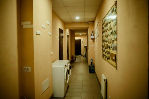 a hallway of a bathroom with a urinal and a hallway sidx sidx at Apartments at Kontorska 10 in Kharkiv