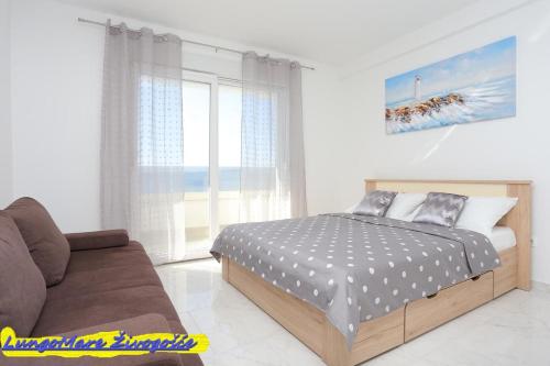 Ένα ή περισσότερα κρεβάτια σε δωμάτιο στο Apartmants villa Lungo Mare