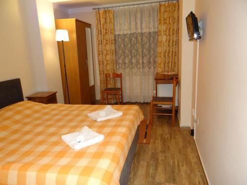 a hotel room with a bed with towels on it at Pension Europa in Prague