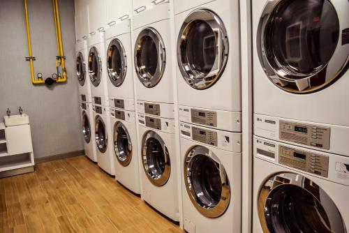 a row of white washing machines in a laundry room at Staybridge Suites Puebla by IHG in Puebla
