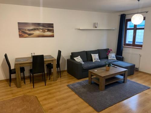 a living room with a couch and a table at Apartmány U Vodního hradu in Česká Lípa