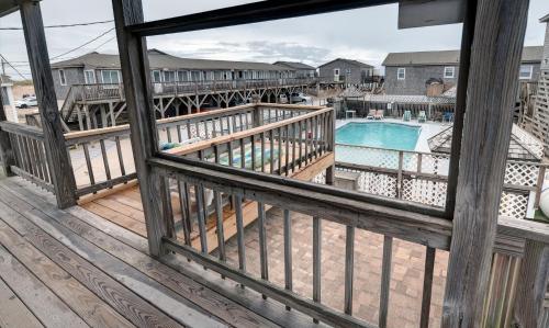 a wooden deck with a view of the water at Outer Banks Motel in Buxton