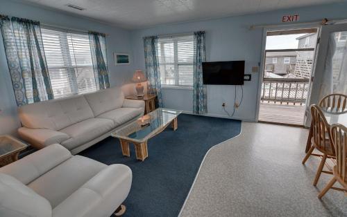 a living room with a couch and a tv at Outer Banks Motel in Buxton
