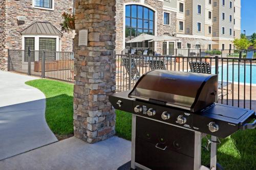 a bbq grill in front of a house at Staybridge Suites Wilmington - Brandywine Valley by IHG in Glen Mills