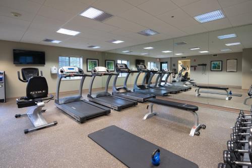 a gym with a row of treadmills and ellipticals at Staybridge Suites Wilmington - Brandywine Valley by IHG in Glen Mills