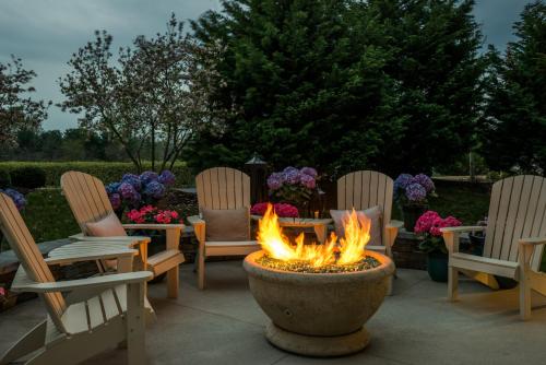a fire pit in a yard with chairs and tables at Staybridge Suites Wilmington - Brandywine Valley by IHG in Glen Mills