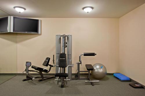 a room with a gym with exercise equipment and a flat screen tv at Staybridge Suites Palmdale by IHG in Palmdale