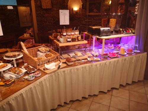 a table with a buffet of food on it at Hotel des Abers in Saint Malo
