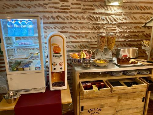 an open refrigerator next to a counter with food at Les Rives du Plantié in Le Temple-sur-Lot