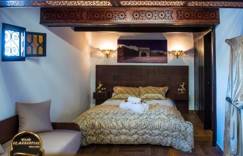 a bedroom with a bed with a stuffed animal on it at Riad EL Manantial,Patrimonio del S XIX in Tetouan