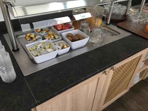 a kitchen counter with several bowls of food on it at Weinhotel Kirchenwirt in Gols