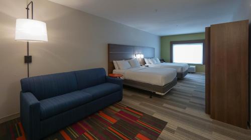 a hotel room with a bed and a couch at Holiday Inn Express Hotel & Suites Savannah Midtown, an IHG Hotel in Savannah