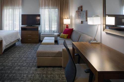 a hotel room with a couch and a bed at Staybridge Suites - Phoenix – Biltmore Area by IHG in Phoenix