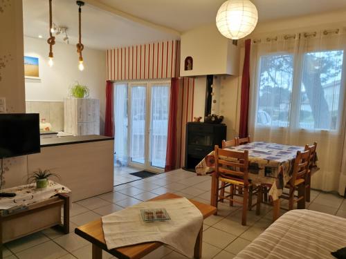 a kitchen and living room with a table and chairs at La Grillotte in Vieux-Boucau-les-Bains