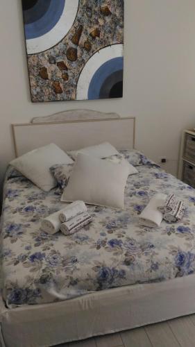 a bed with pillows and towels on it at Il Casalino Apartment in Pizzo