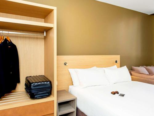 Una cama o camas en una habitación de ibis Budget - Melbourne CBD