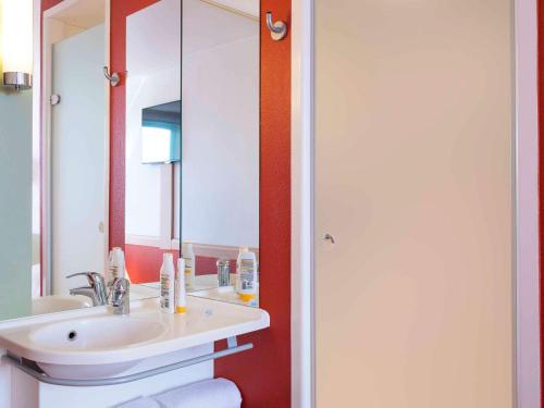 a bathroom with a sink and a mirror at Ibis Budget Lyon Centre - Gare Part Dieu in Lyon