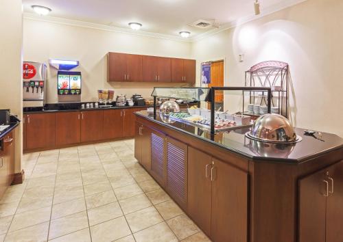 a large kitchen with a counter with a buffet at Staybridge Suites San Antonio Downtown Convention Center by IHG in San Antonio