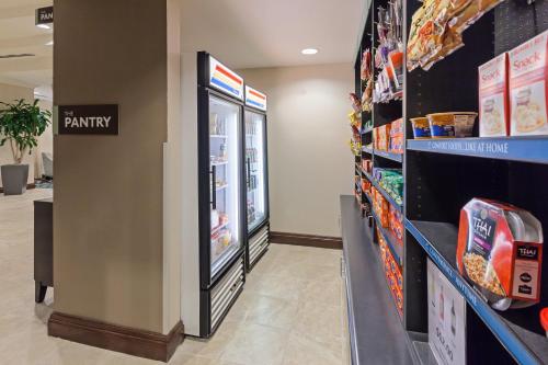 a grocery store aisle with a candy refrigerator at Staybridge Suites San Antonio Downtown Convention Center by IHG in San Antonio