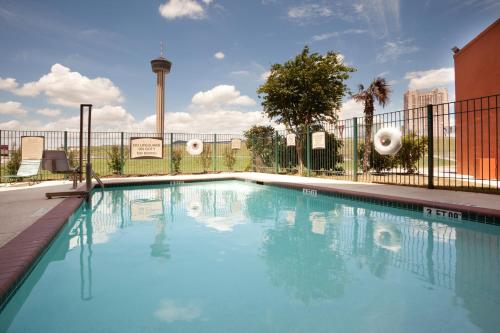 a swimming pool with a fence and blue water at Staybridge Suites San Antonio Downtown Convention Center, an IHG Hotel in San Antonio