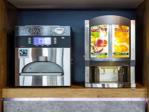 a shelf with a coffee maker and a coffee machine at ibis budget Pau Lescar in Lescar